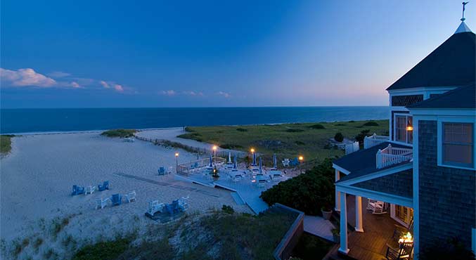 The private beach at dusk at the Beach Resort in Harwich Port showing pristine sands and loungers